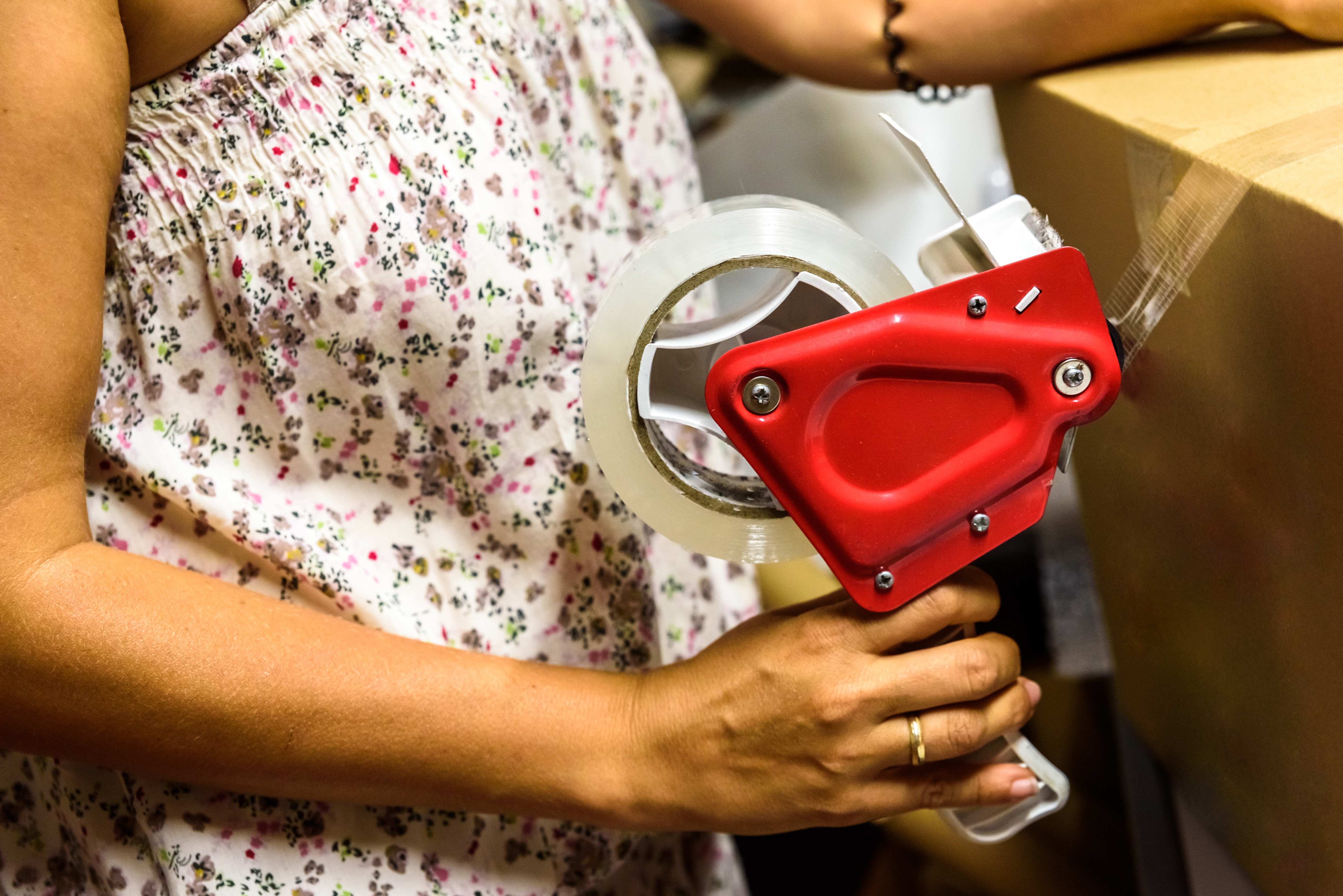 woman taping a package
