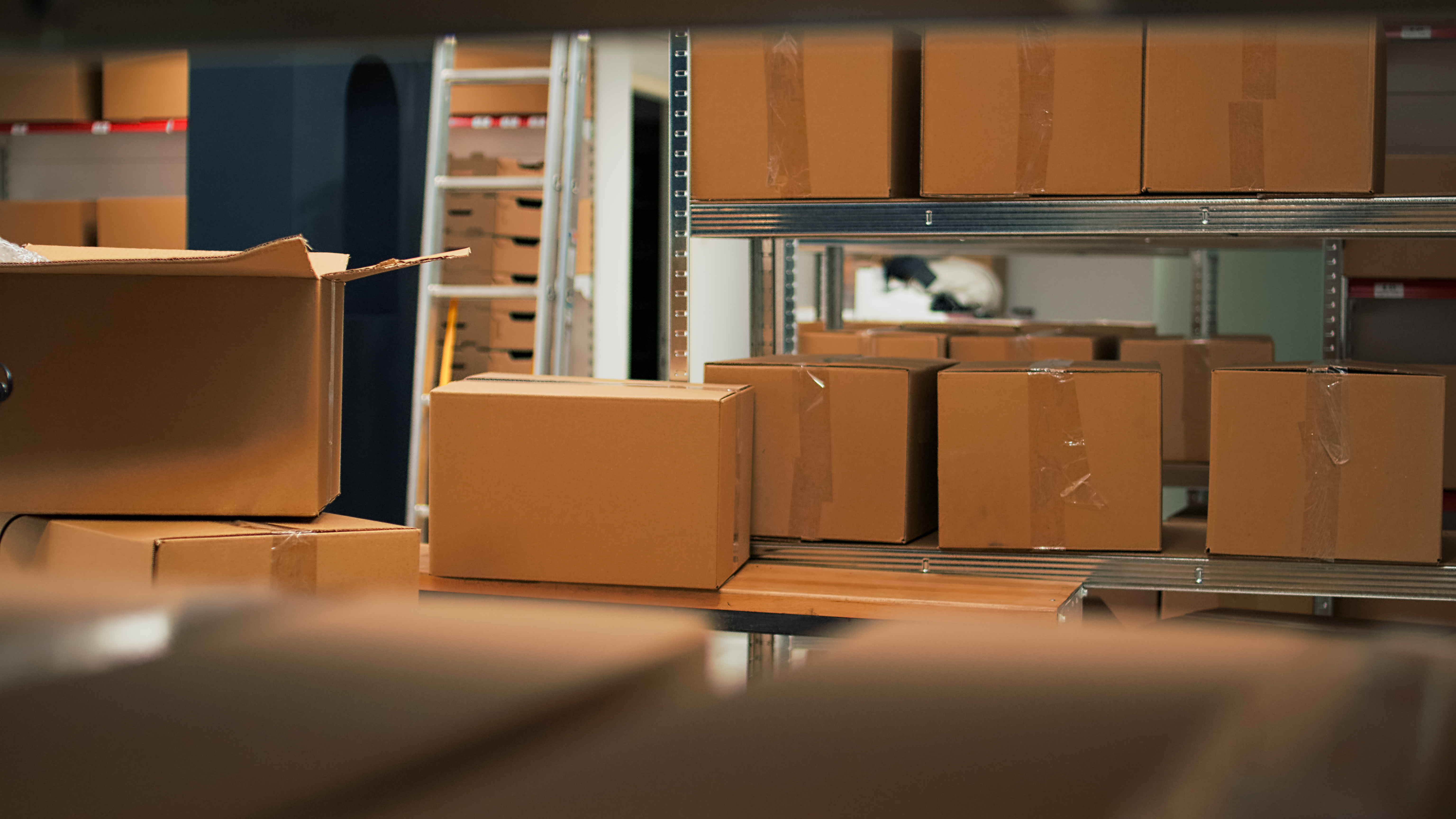 warehouse shelves filled with brown boxes waiting to be shipped