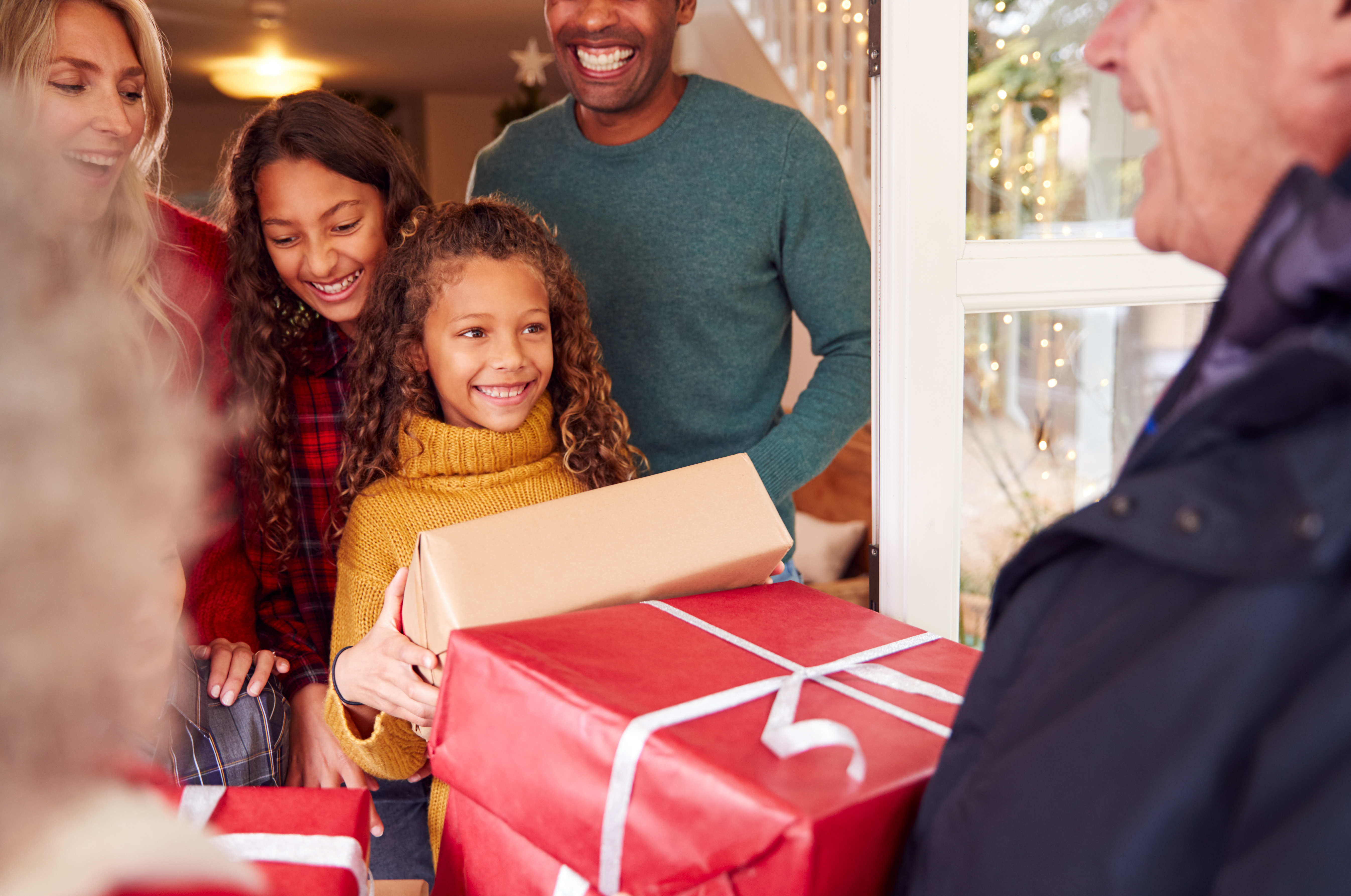 family receiving packages at the front door