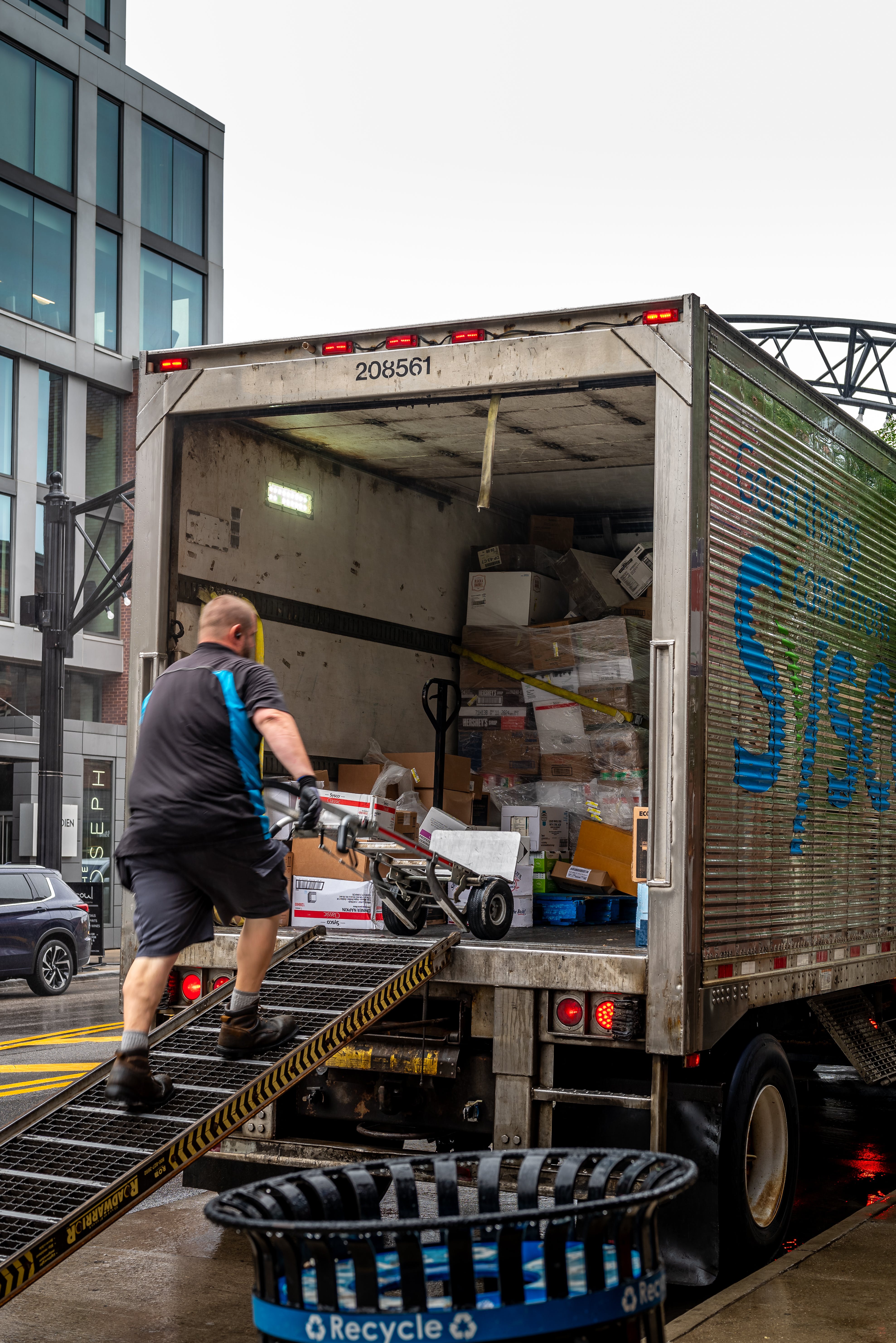 A man loading packages into the back of a semi-truck