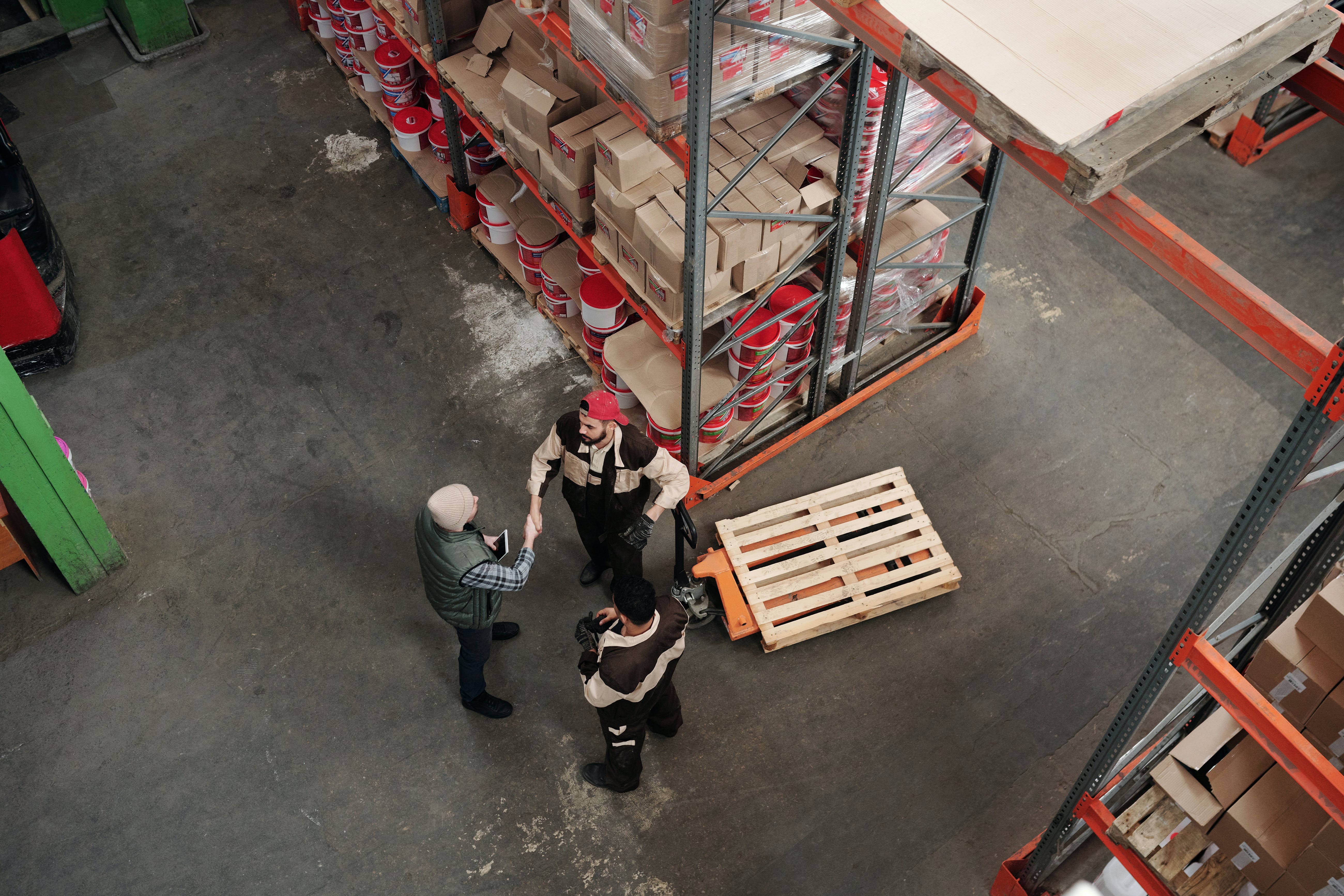 Three people working in a warehouse