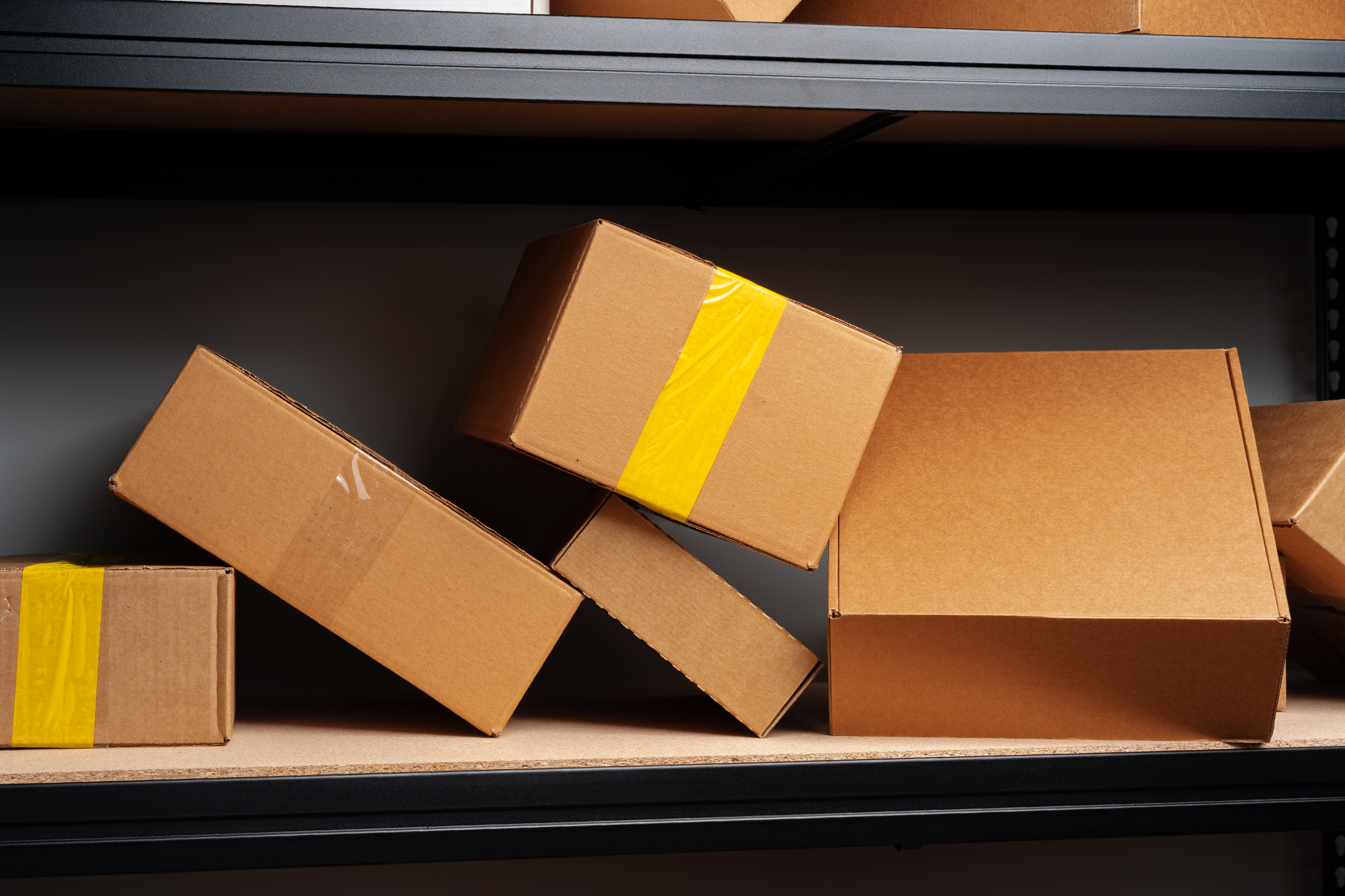 5 scattered packages sitting on a shelf