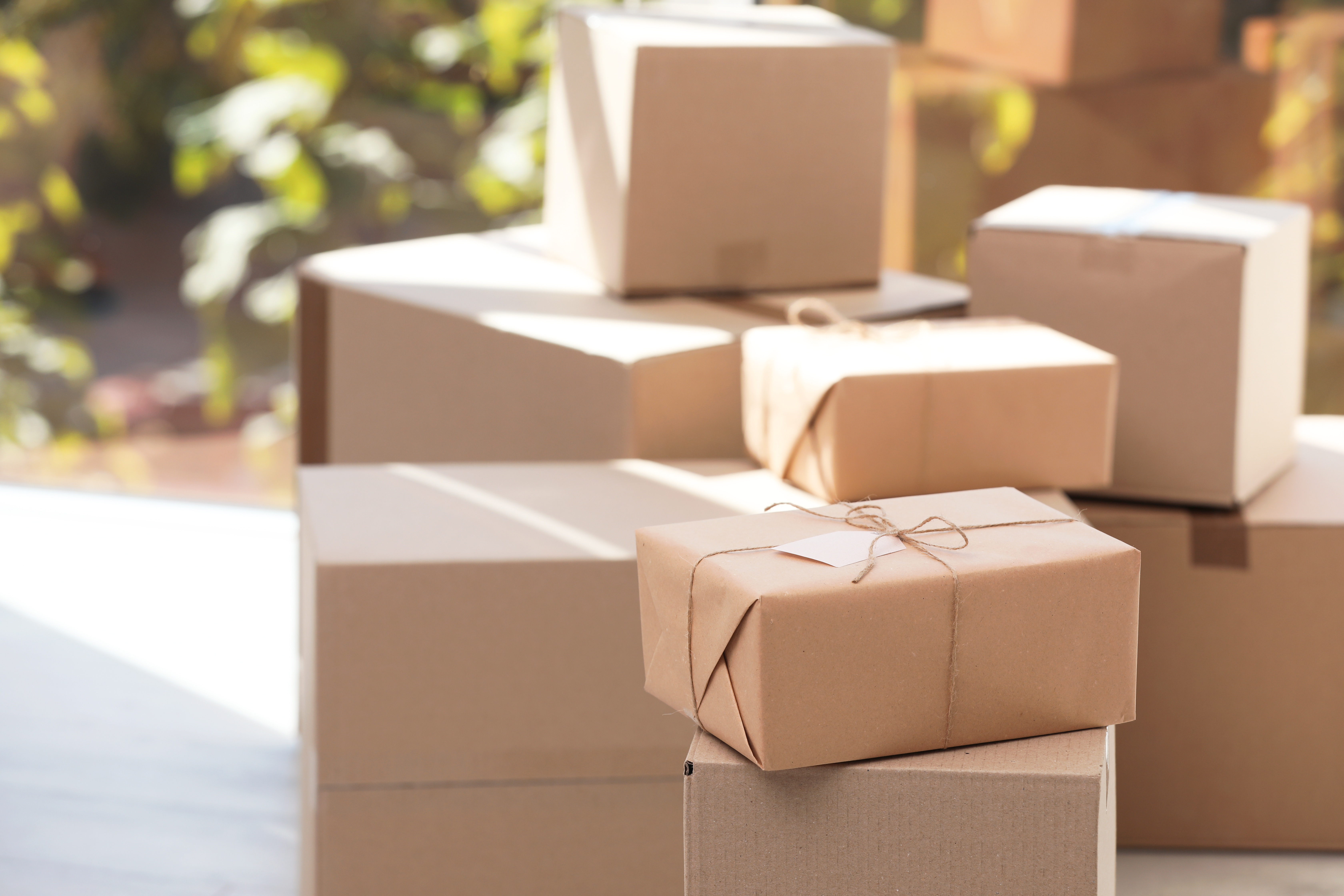 stack of brown boxes in front of a window