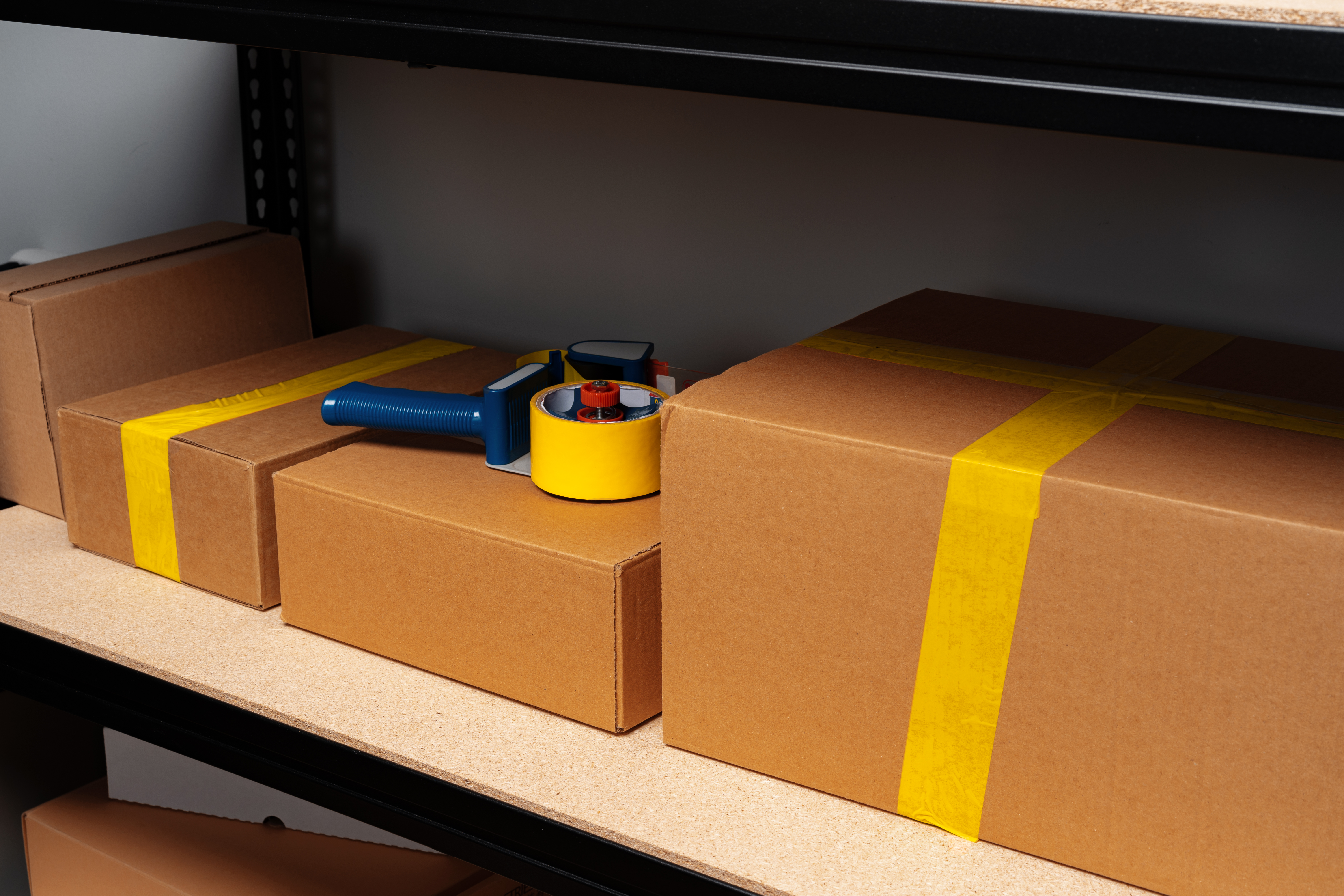 boxes and tape on a shelf