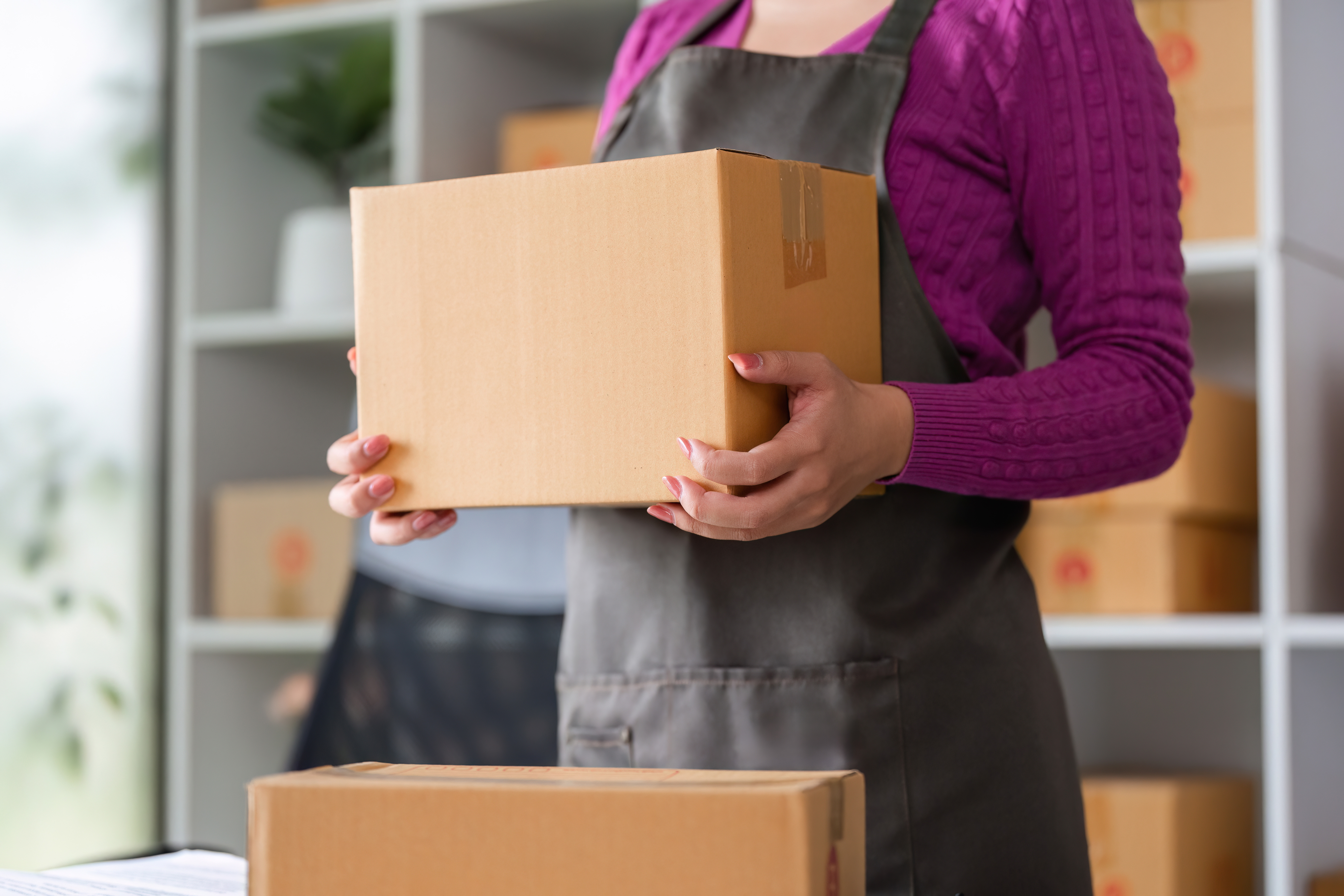 woman holding brown box package