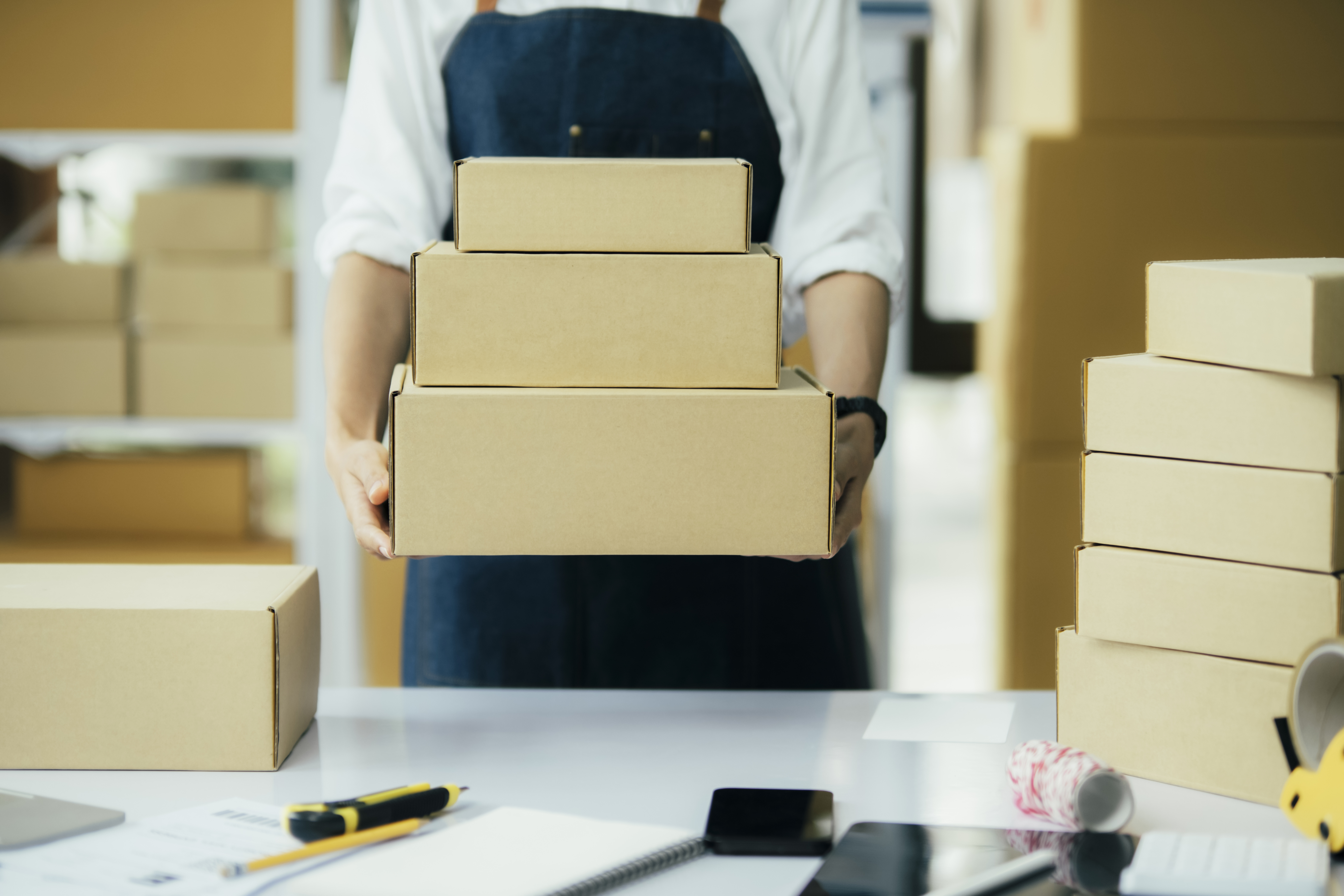 person holding a stack of boxes